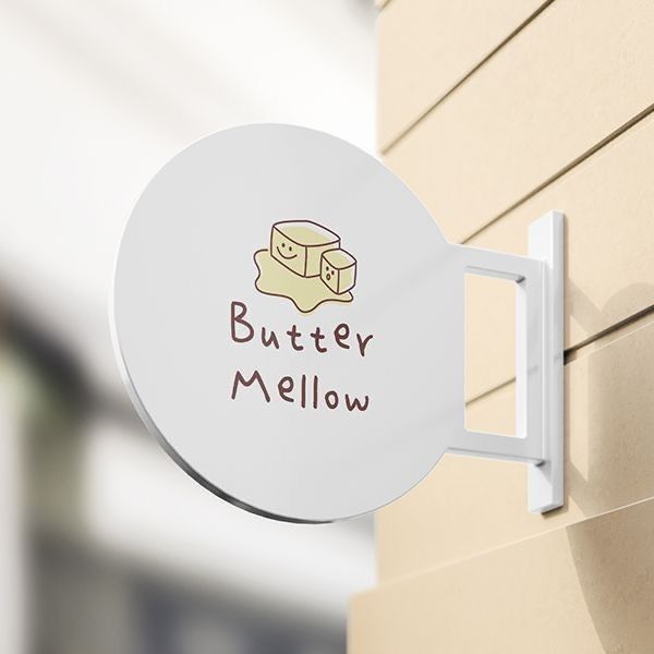 Round signboard with 'Butter Mellow' text and logo on a building exterior.